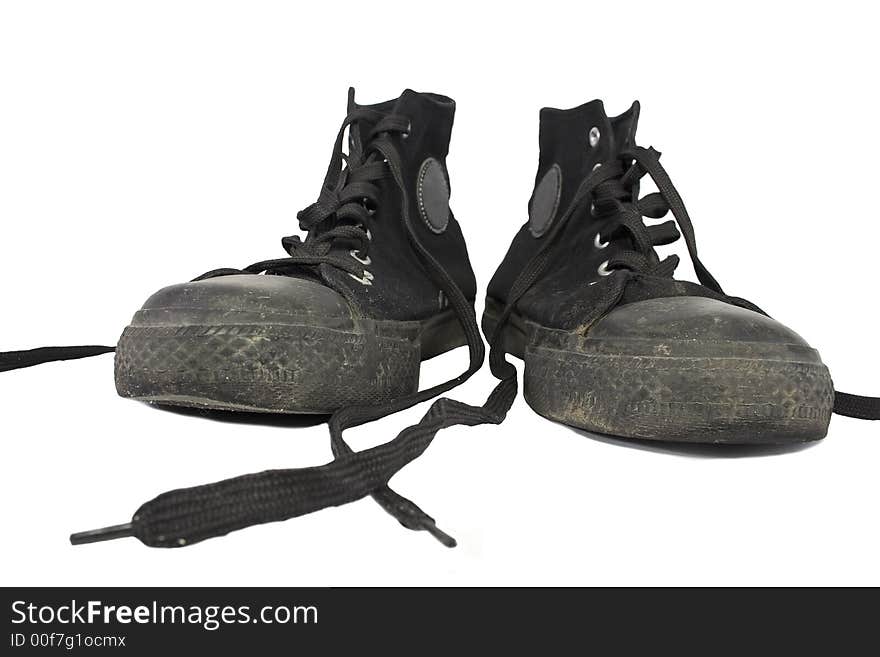 Dirty unlaced black punk`s shoes, isolated with clipping path. Dirty unlaced black punk`s shoes, isolated with clipping path