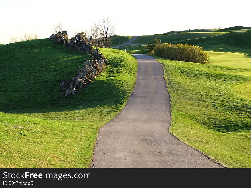 Photo of green golf course with beutiful clouds background. Photo of green golf course with beutiful clouds background