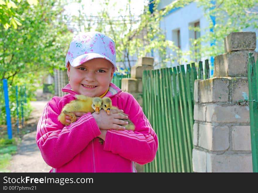 Smiling pretty child and geese