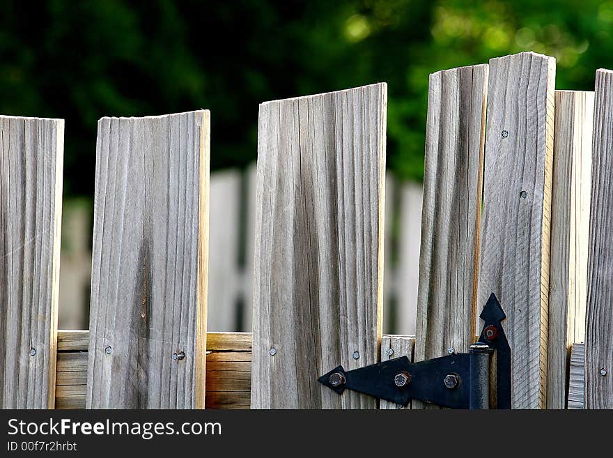 An Old weathered fence and iron hardware. An Old weathered fence and iron hardware