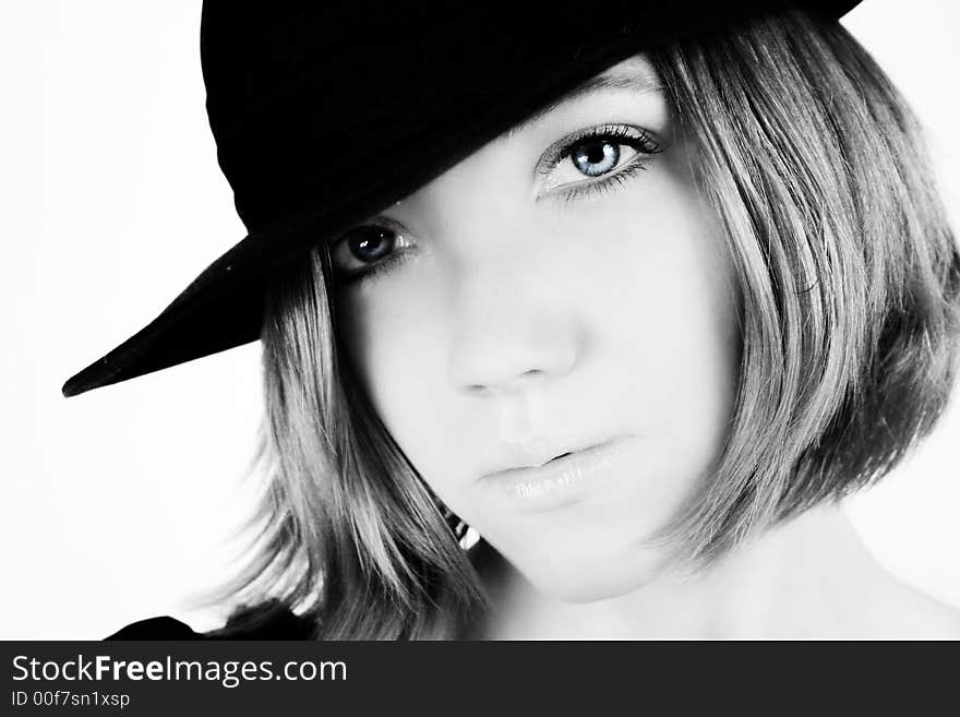 A young beautiful woman with blue eyes is wearing a cowboy hat. A young beautiful woman with blue eyes is wearing a cowboy hat