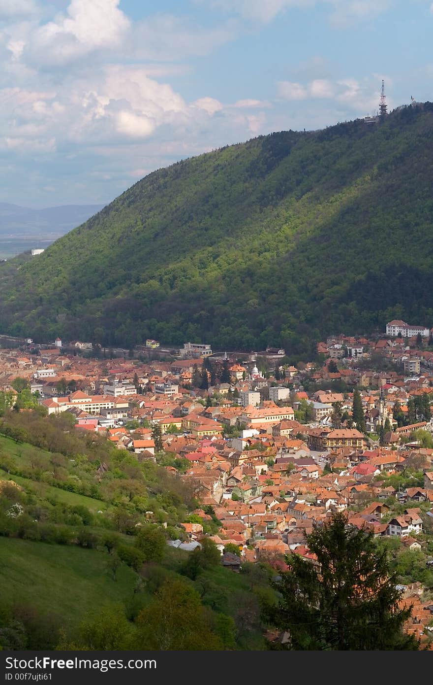 Sunlit city in the valley of steep hillside with some nice shadows. Sunlit city in the valley of steep hillside with some nice shadows