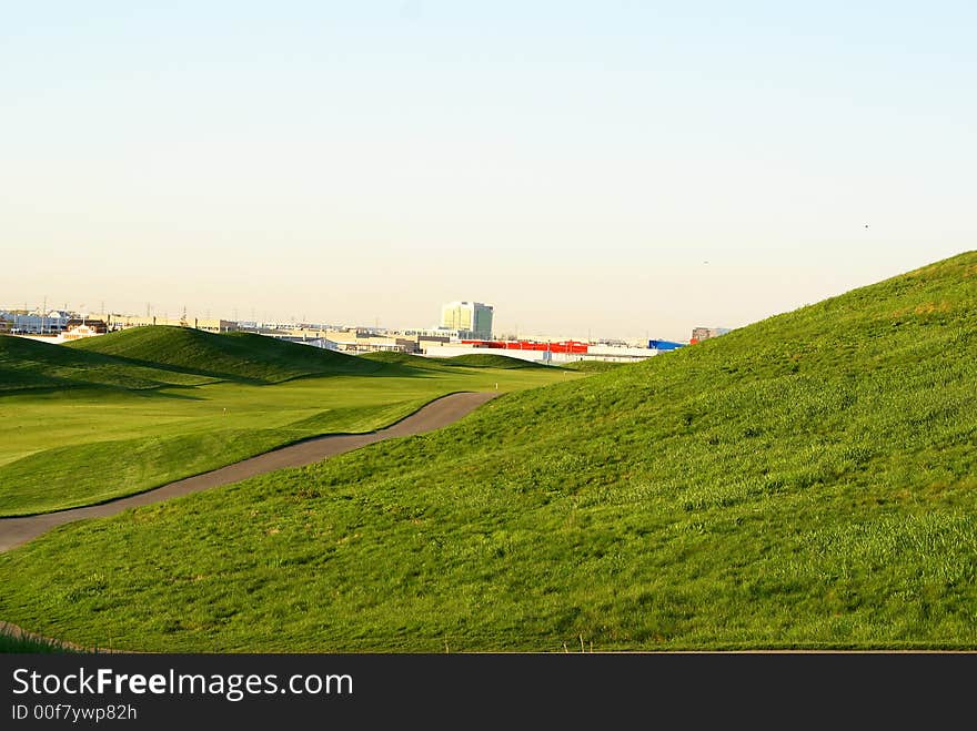 Photo of green golf course with beutiful clouds background. Photo of green golf course with beutiful clouds background