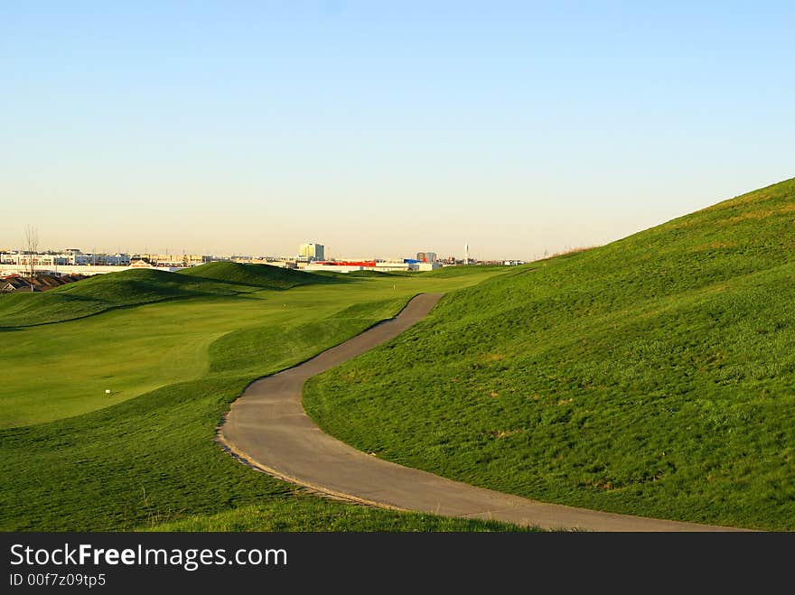 Photo of green golf course with beutiful clouds background. Photo of green golf course with beutiful clouds background