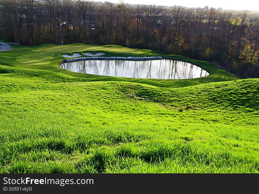 Photo of green golf course with beutiful clouds background. Photo of green golf course with beutiful clouds background