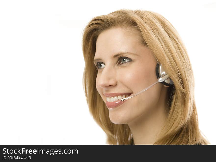 Businesswoman happily uses a headset. Businesswoman happily uses a headset