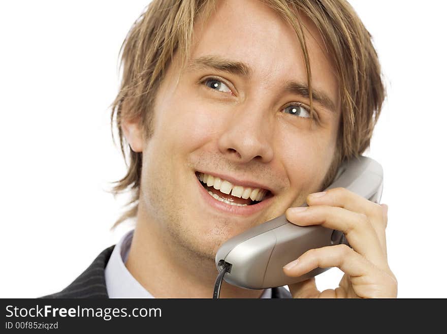 Businessman in a suit uses a corded telephone. Businessman in a suit uses a corded telephone