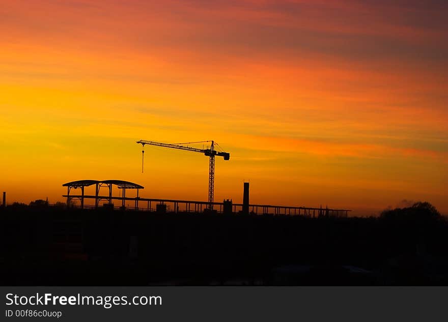 Tower crane in late evening over sunset skies. Tower crane in late evening over sunset skies