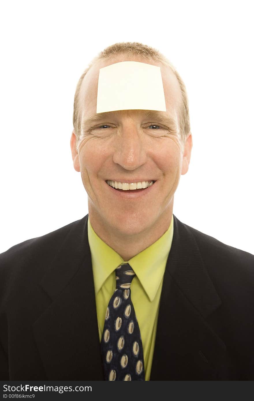 Businessman with a square yellow note stuck to his head. Businessman with a square yellow note stuck to his head