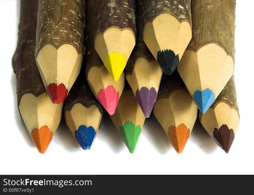 Coloured pencils with pointed tips on a white background