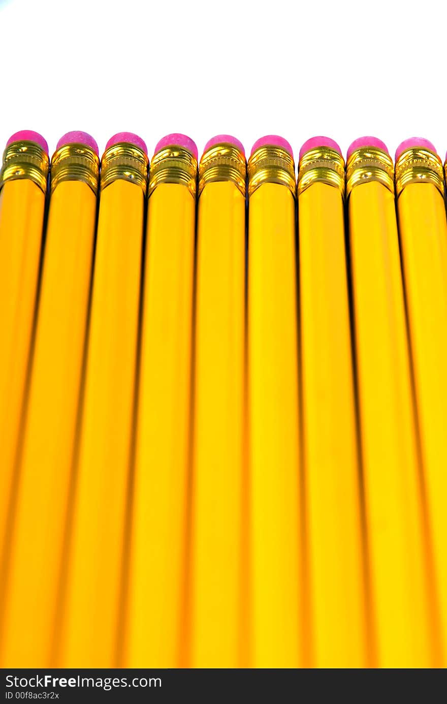 A row of yellow pencils with eraser, isolated over white