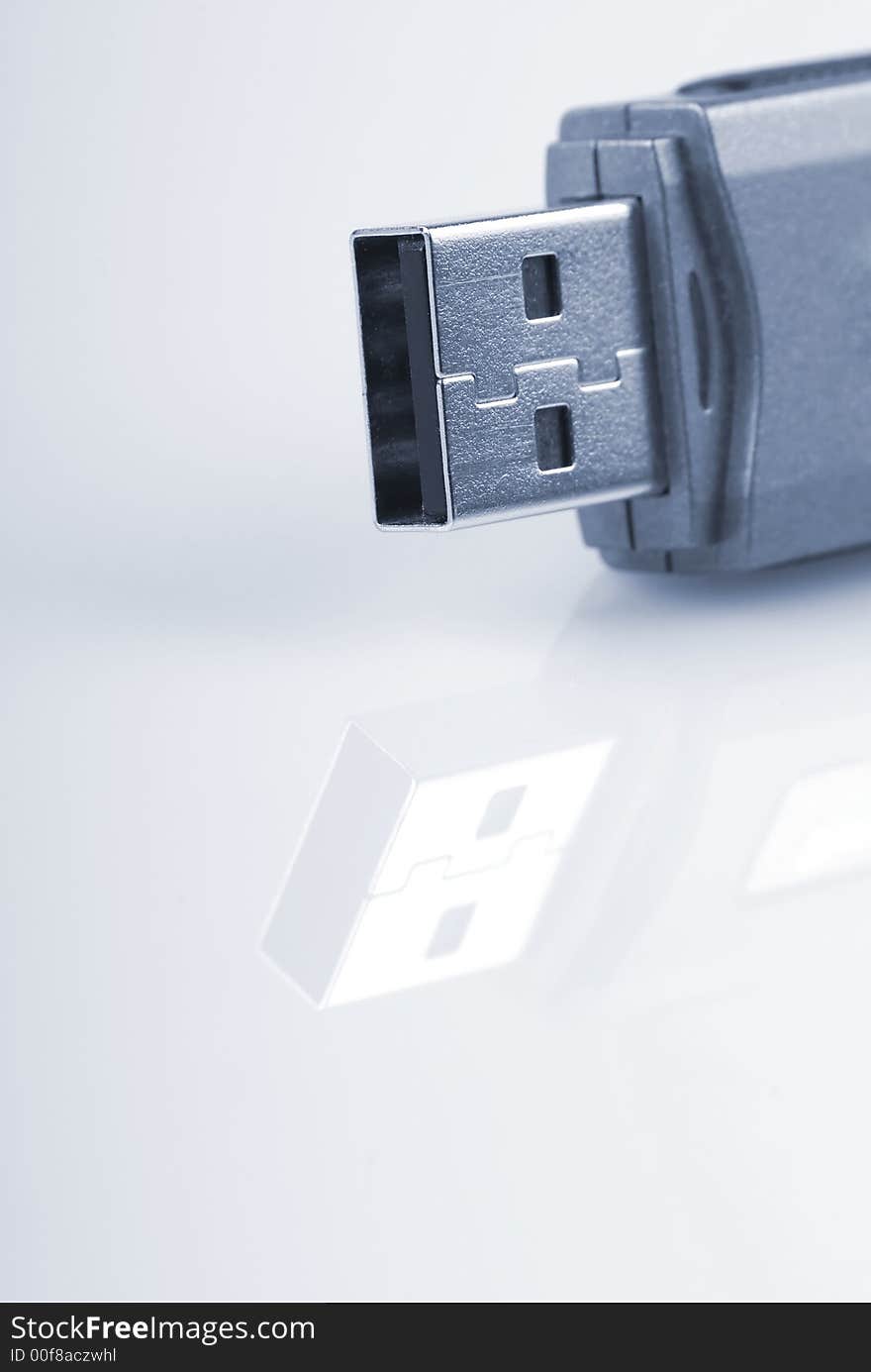 Close-up of usb stick with reflection, isolated