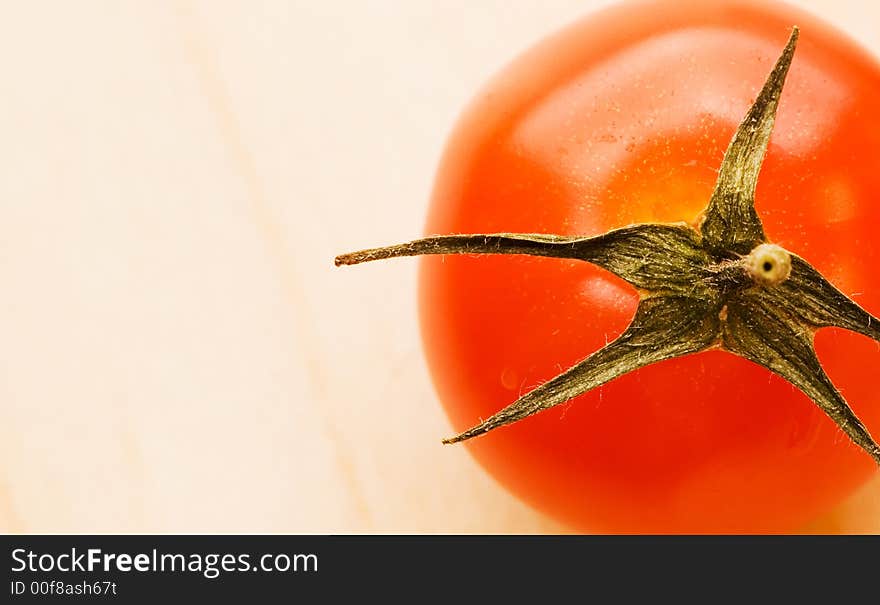 Picture of a Fresh tomato on wooden plate