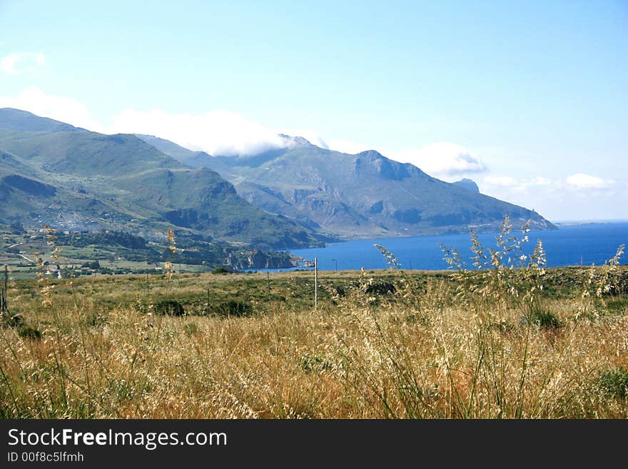 Beautiful view. Countryside, mounts and Mediterranean coast of Scopello. Castellammare del Golfo. Sicily. Italy. Beautiful view. Countryside, mounts and Mediterranean coast of Scopello. Castellammare del Golfo. Sicily. Italy