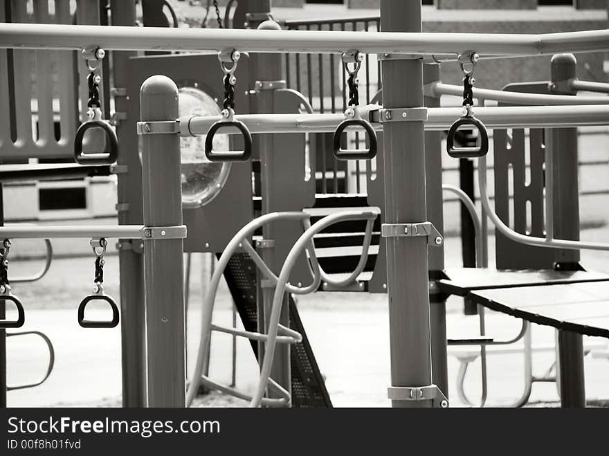 A black and white still photo of an outdoor jungle gym