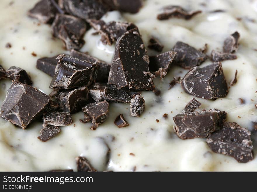 Close-up of chocolate chips in dough soon to be cookies or cake. Close-up of chocolate chips in dough soon to be cookies or cake