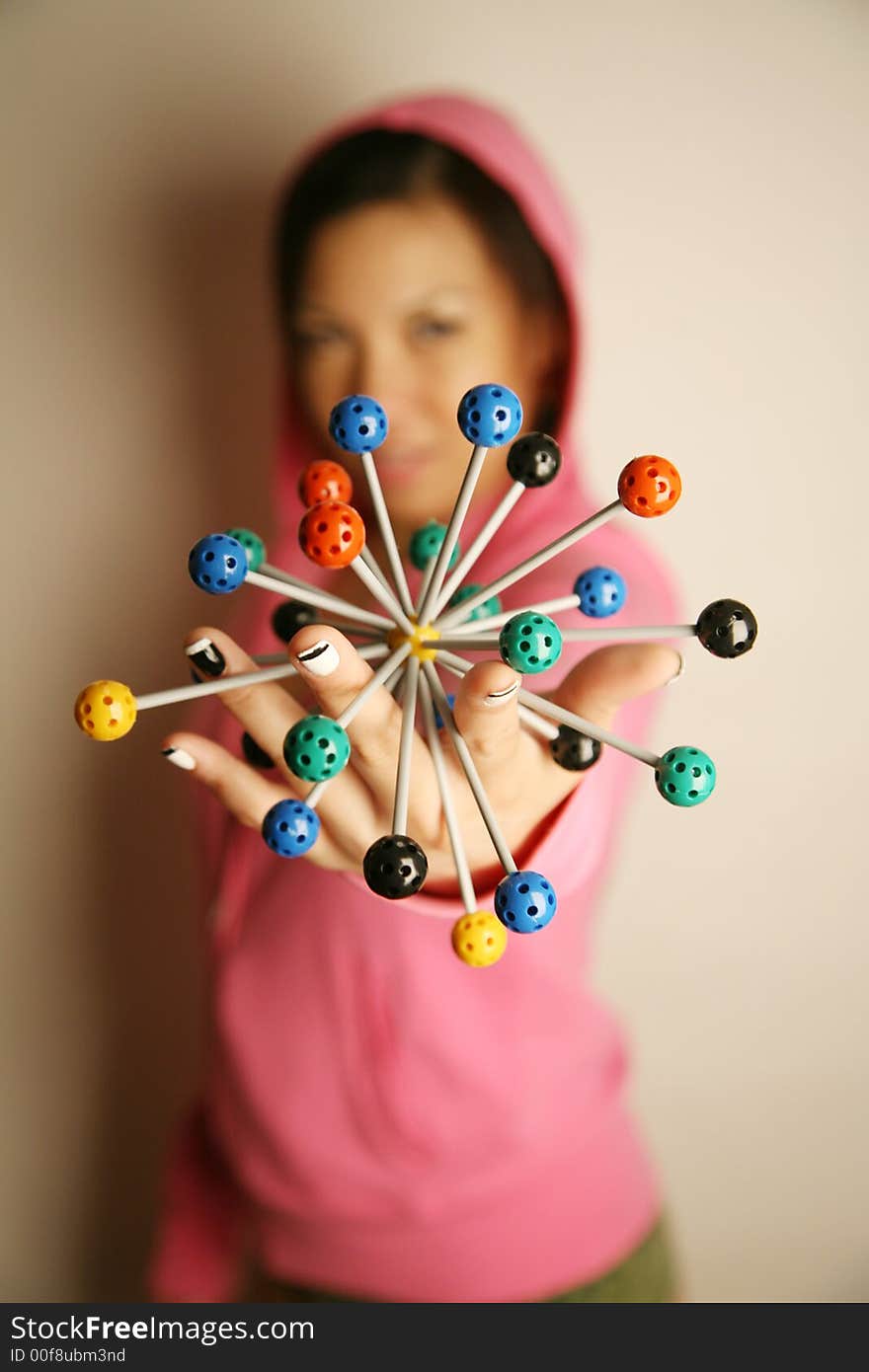 Asian girl holding onto a diagram in 3-dimensions. Asian girl holding onto a diagram in 3-dimensions