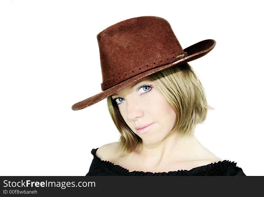 A young beautiful woman with blue eyes is wearing a cowboy hat - stetson. A young beautiful woman with blue eyes is wearing a cowboy hat - stetson