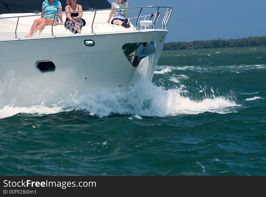 A fishing yacht speeds along the intercoastal waterway in Florida on the way to the ocean. A fishing yacht speeds along the intercoastal waterway in Florida on the way to the ocean