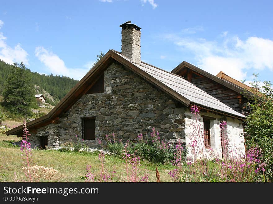 An ancient cottage seen in the Alps where everything is peaceful. An ancient cottage seen in the Alps where everything is peaceful.