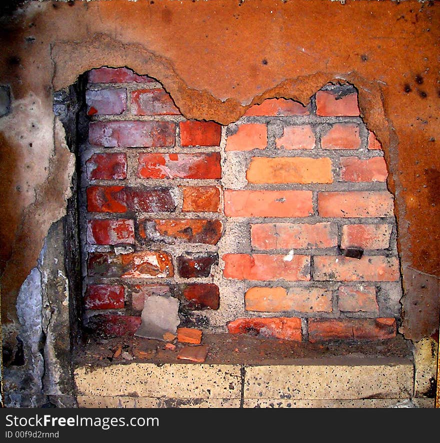 An abstract of an old brick wall behind and rusted-out panel. An abstract of an old brick wall behind and rusted-out panel.