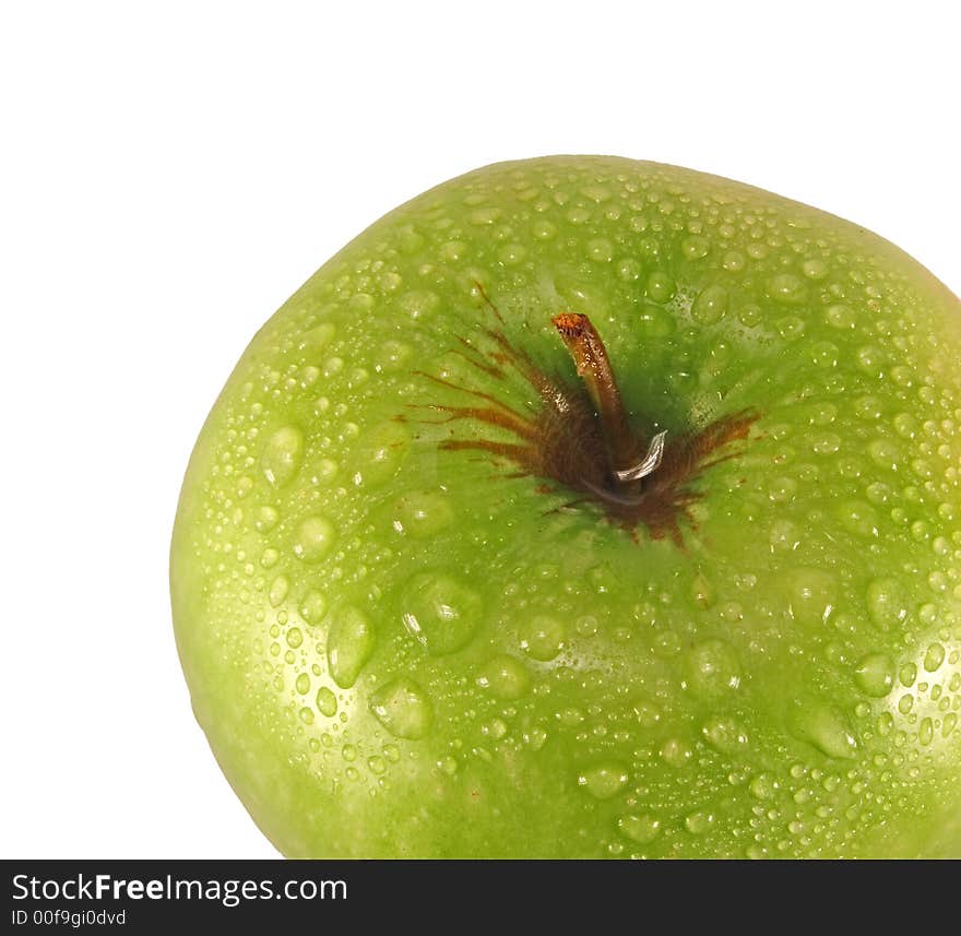 Green apple with drops of water isolated on a white background