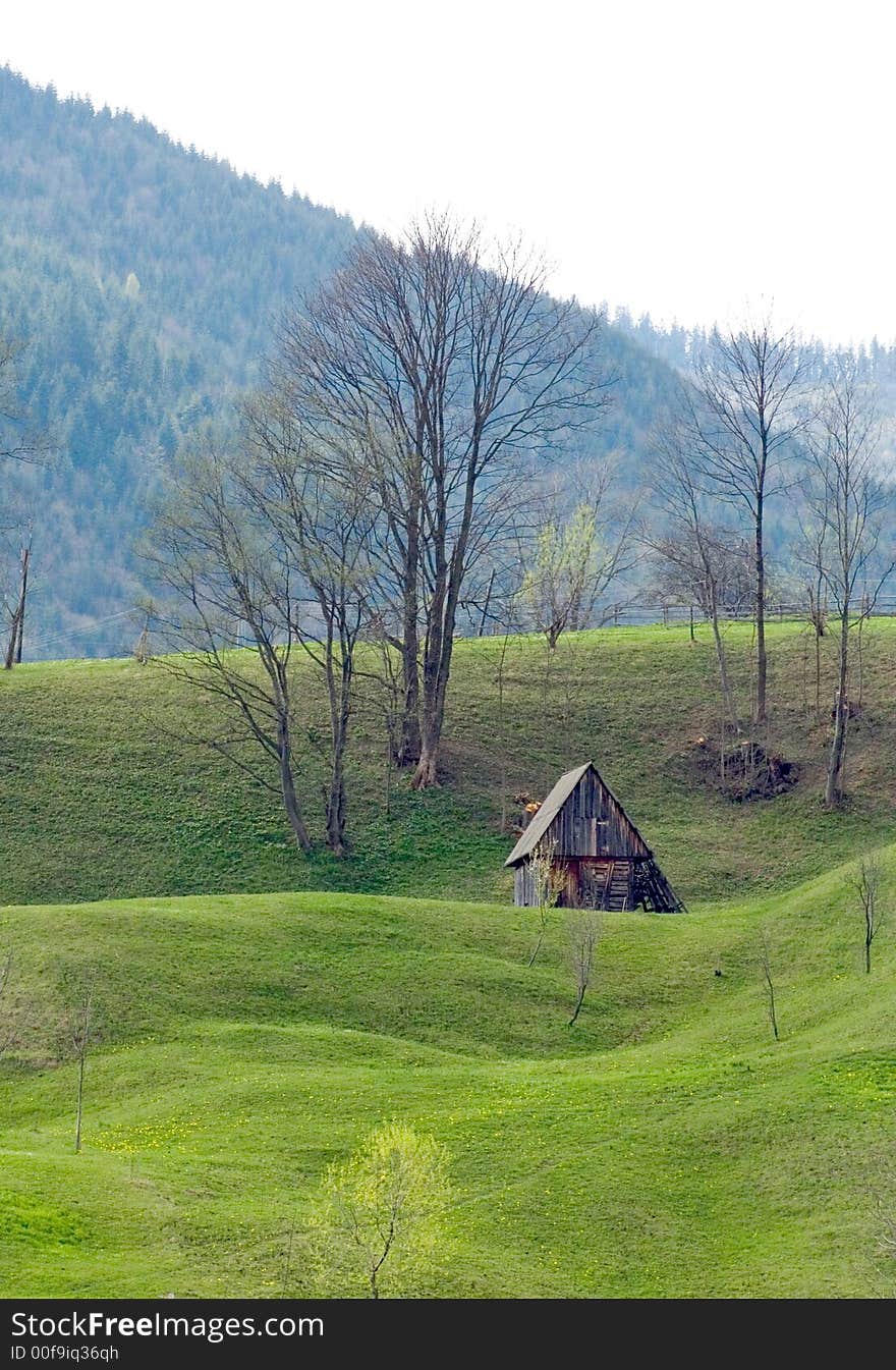 Old wooden house on grassy hill. Old wooden house on grassy hill
