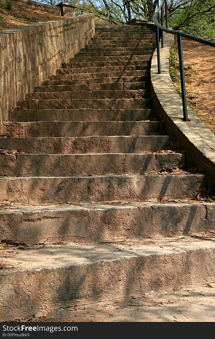 A set of stone and concrete stairs rising into the distance. A set of stone and concrete stairs rising into the distance