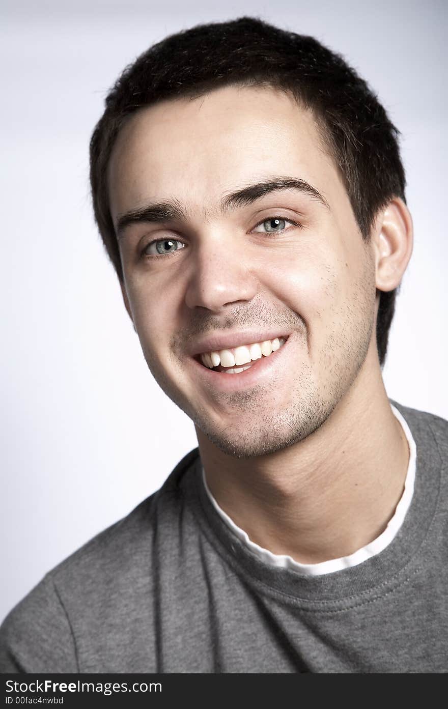 Smiling attractive young man on plain background. Smiling attractive young man on plain background