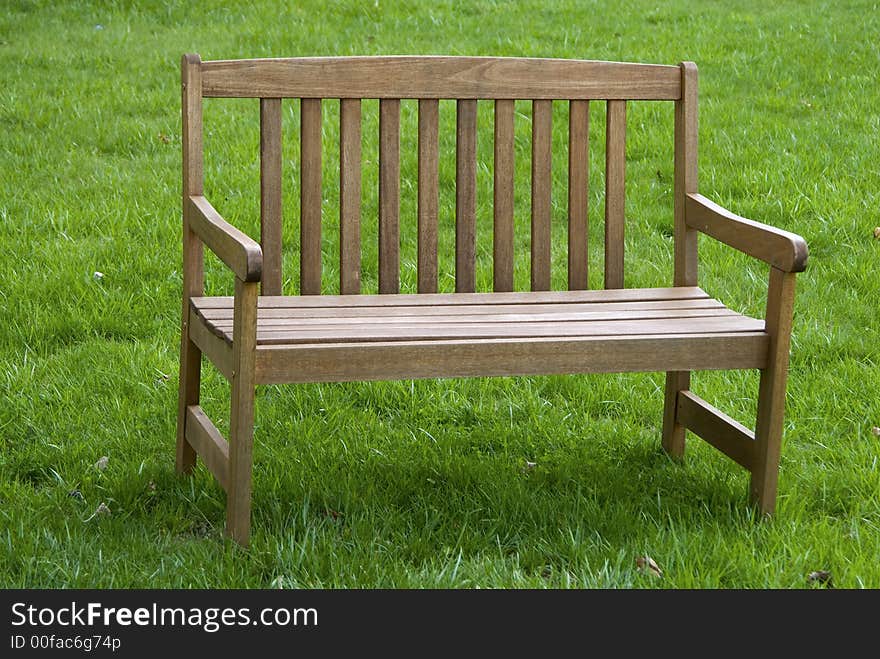 An empty bench at a local park ona sunny summer day. An empty bench at a local park ona sunny summer day