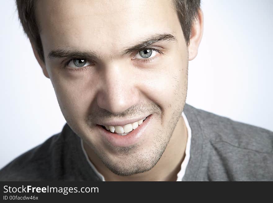 Smiling attractive young man on plain background. Smiling attractive young man on plain background