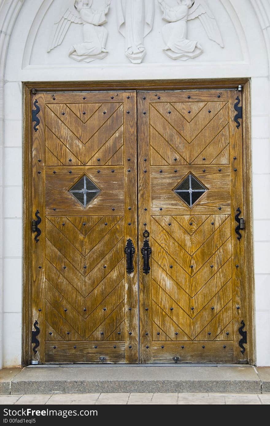 An old antique door on a local roman catholic church. An old antique door on a local roman catholic church