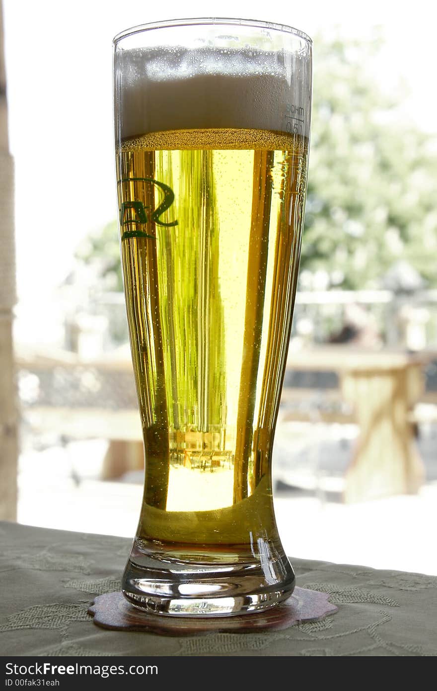 Glass of beer on street cafe terrace background