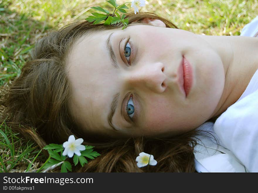 Beautiful young female face with flowers. Beautiful young female face with flowers