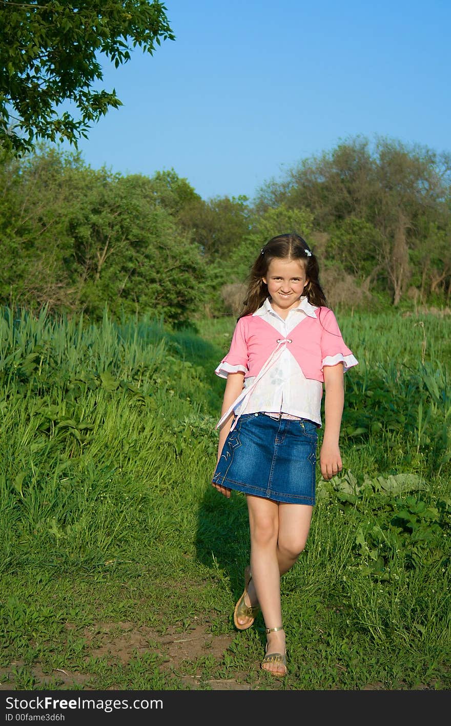 Happy girl on the edge of the wood