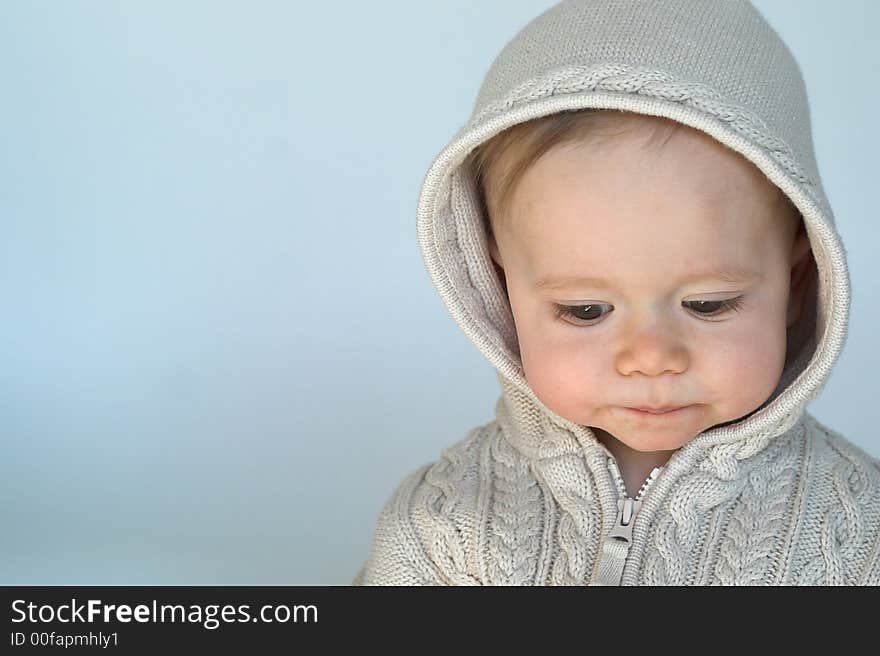 Image of cute baby wearing a hooded sweater. Image of cute baby wearing a hooded sweater