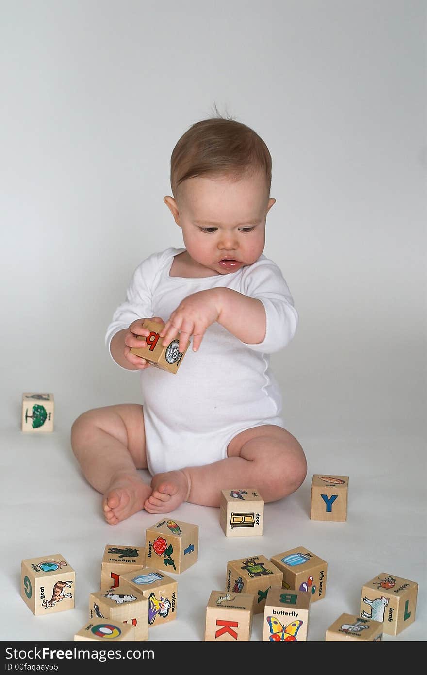 Image of cute baby playing with alphabet blocks. Image of cute baby playing with alphabet blocks