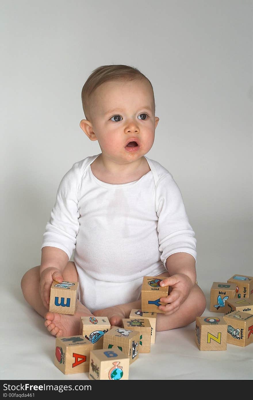 Image of cute baby playing with alphabet blocks. Image of cute baby playing with alphabet blocks