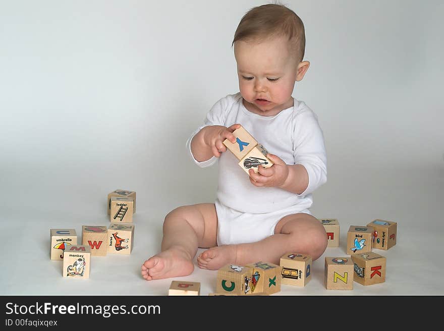 Image of cute baby playing with alphabet blocks. Image of cute baby playing with alphabet blocks