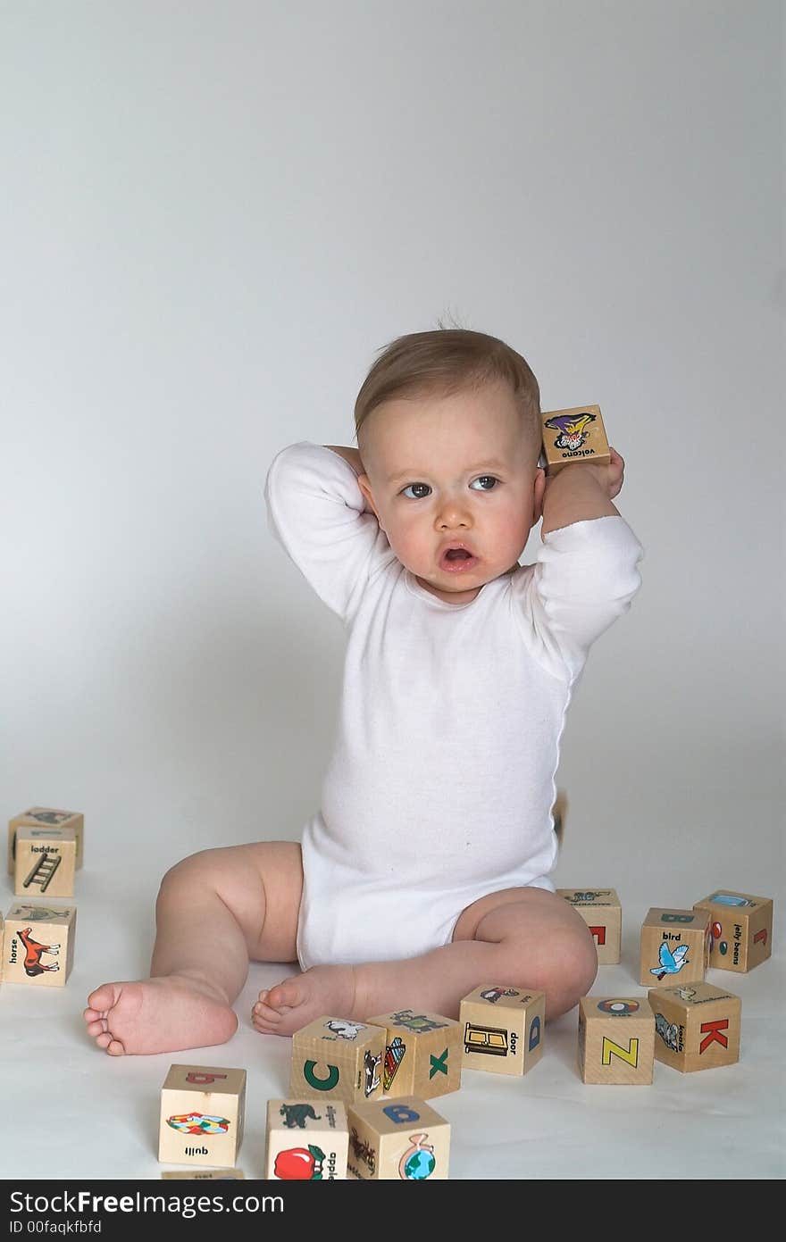 Image of cute baby playing with alphabet blocks. Image of cute baby playing with alphabet blocks