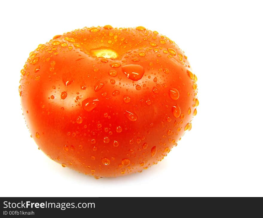 Tomato with drops on a white background. Tomato with drops on a white background.