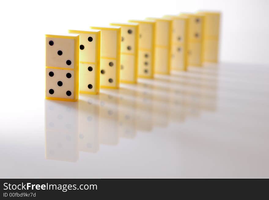 DOmino blocks in a row, illuminated from left