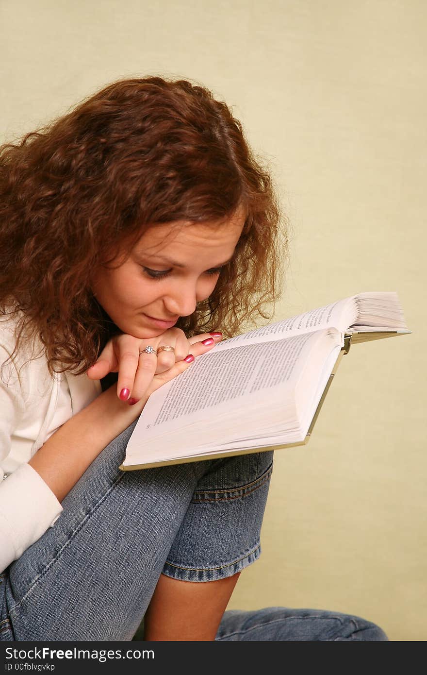 The young girl reads the book. The young girl reads the book