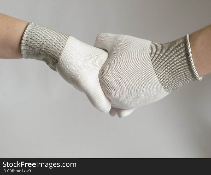 Male and female handshake with gloves