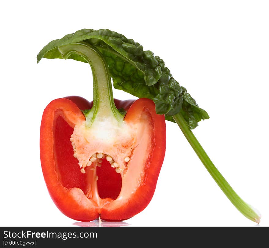 Sliced paprika and spinach leaf over white background