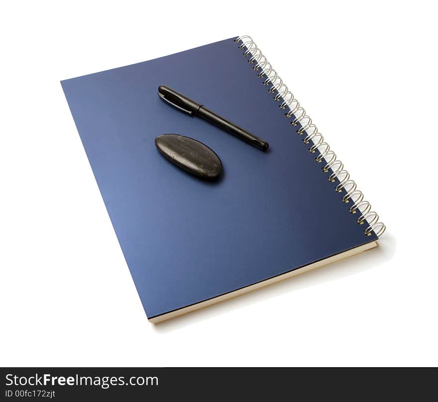 Organizer and pen and black pebble isolated over white background. Organizer and pen and black pebble isolated over white background