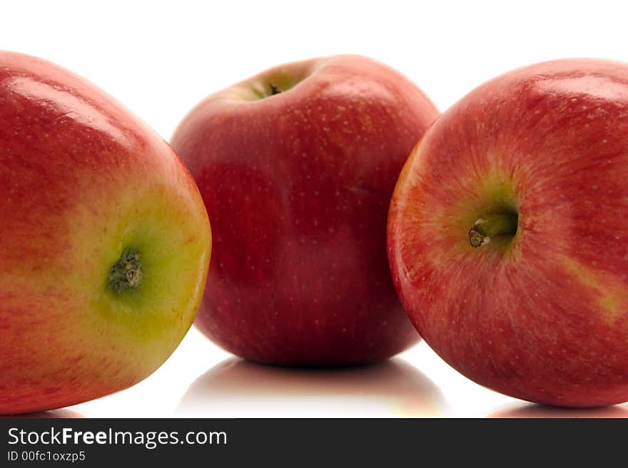 Tree red apples over white background