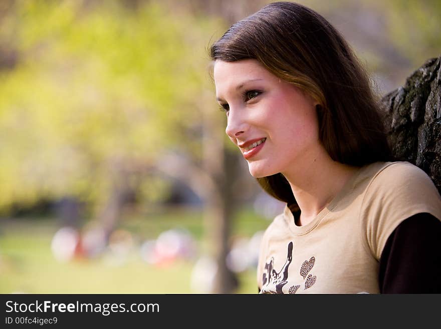 Beautiful young woman in nature looks dreamy