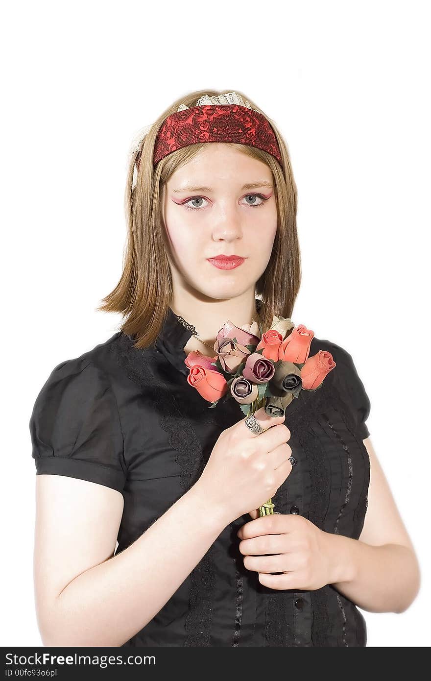 A pretty young woman in a black blouse holds a bunch of flowers. A pretty young woman in a black blouse holds a bunch of flowers