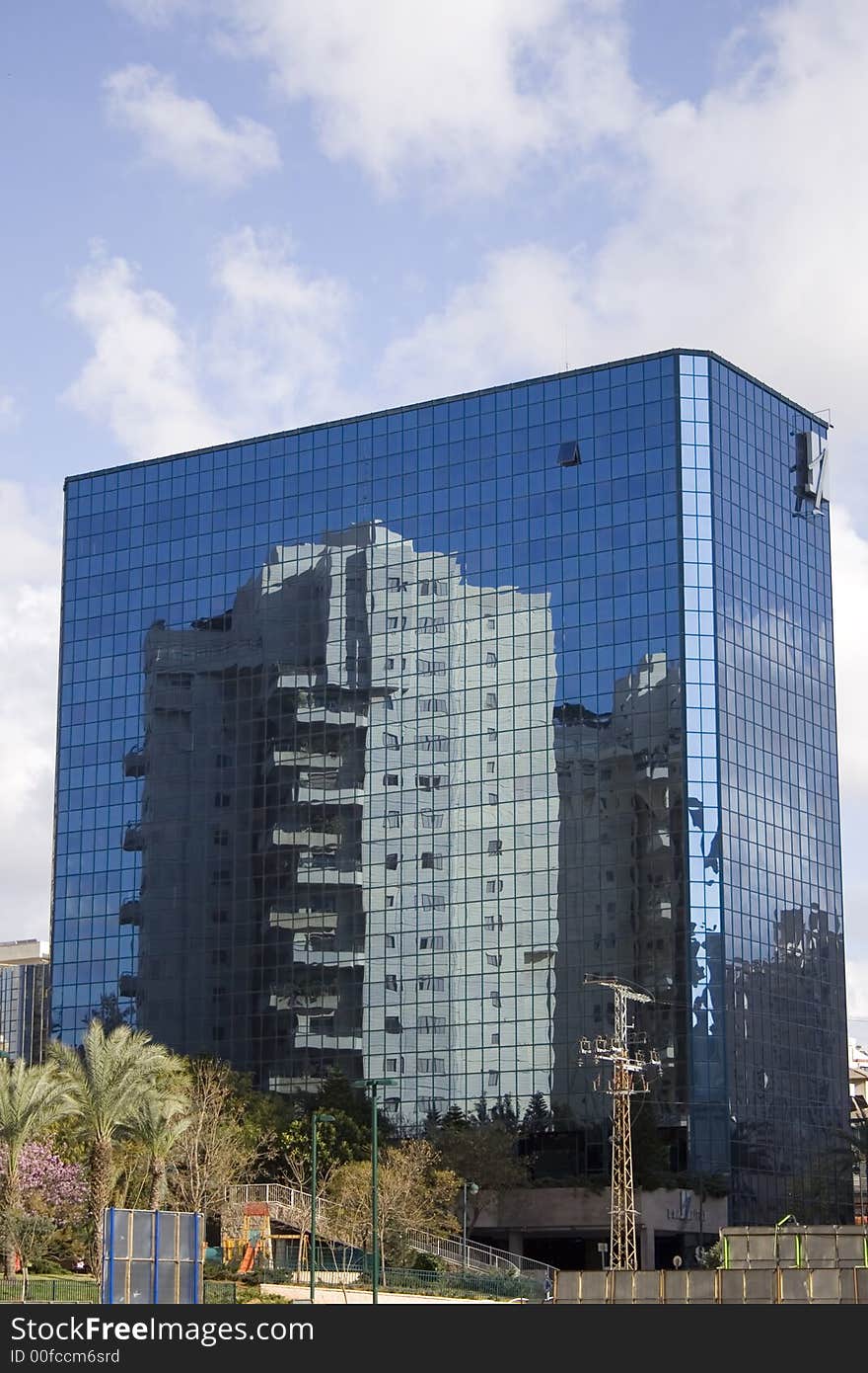 Glass tower with reflection of building